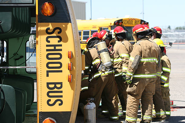 Firefighters extricating students from wrecked school bus.