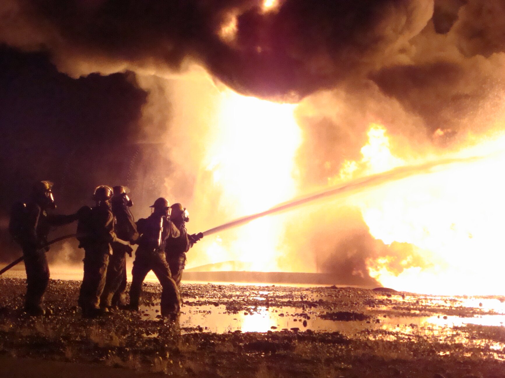 firefighters fighting fire with water