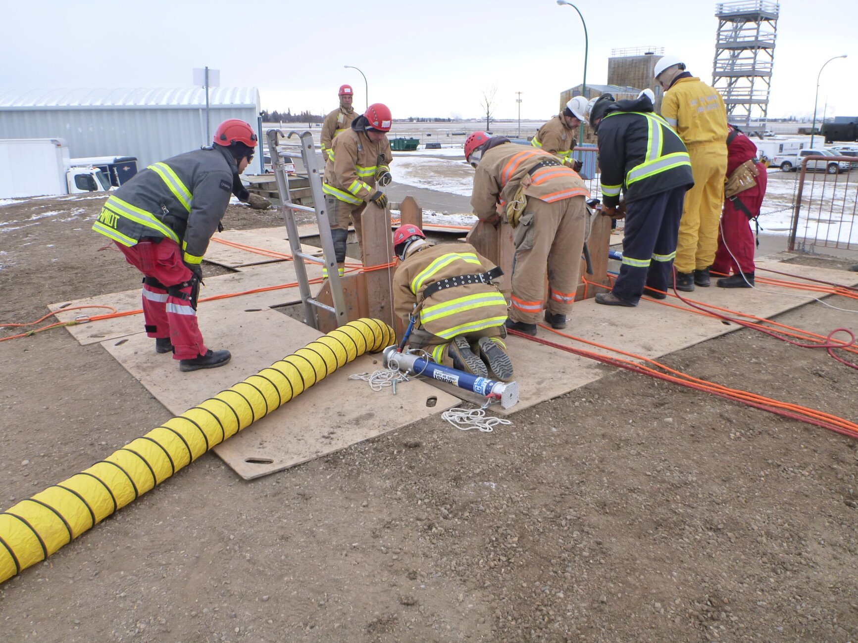 firefighters around hole